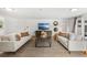 Spacious living room featuring two sofas, a decorative rug, and natural light from French doors at 927 Boardman St, Orlando, FL 32804