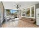 Relaxing enclosed porch with tile flooring, ceiling fan, seating and backyard views at 927 Boardman St, Orlando, FL 32804