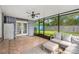 Inviting enclosed porch featuring comfortable seating and views of the landscaped backyard at 927 Boardman St, Orlando, FL 32804