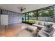 Inviting screened patio featuring tile flooring and a comfortable seating area at 927 Boardman St, Orlando, FL 32804