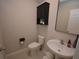 Powder room featuring a modern toilet, vanity with vessel sink and an above the counter mirrored cabinet at 971 Desert Candle Dr, Ocoee, FL 34761