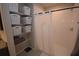 Bathroom features tile shower with glass door, white storage baskets, and a gray vanity at 971 Desert Candle Dr, Ocoee, FL 34761