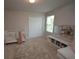 Bedroom featuring a white crib, a plush rug and a storage bench at 971 Desert Candle Dr, Ocoee, FL 34761