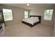 Bright bedroom with neutral carpet, three windows with blinds, and a bed with white linens at 971 Desert Candle Dr, Ocoee, FL 34761
