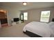 Large primary bedroom with ensuite bathroom and ample natural light from two windows at 971 Desert Candle Dr, Ocoee, FL 34761