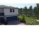 Charming exterior with a blue garage door, brick driveway, and mature landscaping at 971 Desert Candle Dr, Ocoee, FL 34761