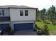 A lovely townhouse with a large blue garage door, brick driveway and landscaped yard at 971 Desert Candle Dr, Ocoee, FL 34761