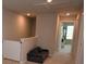 Upstairs hallway with a small sofa and access to bedrooms at 971 Desert Candle Dr, Ocoee, FL 34761