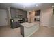 Modern eat-in kitchen with grey cabinets, granite countertops, stainless steel appliances, and tiled floors at 971 Desert Candle Dr, Ocoee, FL 34761