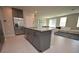 Stylish eat-in kitchen with granite countertop island, stainless steel appliances, and open floor plan at 971 Desert Candle Dr, Ocoee, FL 34761