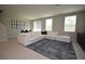 Spacious living room with large sectional sofa, modern rug, and plenty of natural light at 971 Desert Candle Dr, Ocoee, FL 34761