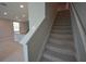 Carpeted staircase leading to the second floor, with view of kitchen area at 971 Desert Candle Dr, Ocoee, FL 34761