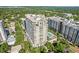 An aerial view of a modern, high-rise condo building, showcasing beautiful balconies and surrounding greenery at 100 S Eola Dr # 1406, Orlando, FL 32801