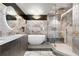 Spa-like bathroom featuring a modern tub, glass shower, and stylish marble tiling at 100 S Eola Dr # 1406, Orlando, FL 32801