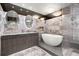 Elegant bathroom with dual sinks, a soaking tub, and modern fixtures at 100 S Eola Dr # 1406, Orlando, FL 32801
