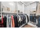 Bright walk-in closet with organized hanging rods and storage for a variety of clothes at 100 S Eola Dr # 1406, Orlando, FL 32801