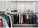 Bright walk-in closet with organized hanging rods and storage for a variety of clothes at 100 S Eola Dr # 1406, Orlando, FL 32801