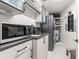 Well-organized laundry room features modern appliances, sleek cabinets, and a granite countertop at 100 S Eola Dr # 1406, Orlando, FL 32801