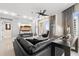 Cozy living room with a black leather sofa, modern entertainment unit, and expansive windows providing ample natural light at 100 S Eola Dr # 1406, Orlando, FL 32801