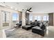 Spacious living room featuring sleek black furniture, large windows with city views, and modern decor elements at 100 S Eola Dr # 1406, Orlando, FL 32801