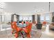 Bright, spacious living room with expansive windows and stylish furnishings, including modern dining set and decor at 100 S Eola Dr # 1406, Orlando, FL 32801