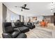 Open-concept living area with sleek black furniture, modern lighting, and expansive windows offering scenic views at 100 S Eola Dr # 1406, Orlando, FL 32801