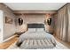 Modern bedroom features decorative lighting, stylish headboard, and hardwood floors at 100 S Eola Dr # 1406, Orlando, FL 32801
