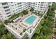 Relaxing outdoor pool area with cabanas and lounge chairs within a modern condo complex at 100 S Eola Dr # 1406, Orlando, FL 32801