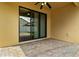 Covered back porch with tile floor, ceiling fan and sliding glass door at 10111 Tierra Bella Dr, Orlando, FL 32825
