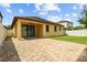 Home's backyard featuring a brick patio, a grassy area, and privacy fencing at 10111 Tierra Bella Dr, Orlando, FL 32825