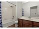 Bathroom featuring vanity with storage and tiled shower/tub combo at 10111 Tierra Bella Dr, Orlando, FL 32825