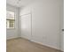 Bedroom with neutral carpet, a ceiling fan, and a double closet at 10111 Tierra Bella Dr, Orlando, FL 32825