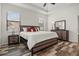 Bright bedroom featuring wood-look floors, a ceiling fan, and coordinated furniture set at 10111 Tierra Bella Dr, Orlando, FL 32825