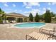 Community pool with lounge chairs and covered seating area at 10111 Tierra Bella Dr, Orlando, FL 32825