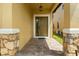Inviting front entrance with stone pillars and brick pavers, creating a warm welcome at 10111 Tierra Bella Dr, Orlando, FL 32825