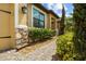 Close up of walkway, stone accents and manicured landscaping add elegance to the exterior at 10111 Tierra Bella Dr, Orlando, FL 32825