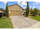 Charming home with a paved driveway, verdant lawn and mature trees providing a serene setting at 10111 Tierra Bella Dr, Orlando, FL 32825