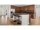 Spacious kitchen featuring an island with barstool seating, granite countertops, and stainless steel appliances at 10111 Tierra Bella Dr, Orlando, FL 32825