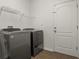 Laundry room featuring a washer and dryer, tile flooring, and overhead storage at 10111 Tierra Bella Dr, Orlando, FL 32825
