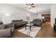Bright and open living room with sofas, ceiling fan, and a combined kitchen and dining area at 10111 Tierra Bella Dr, Orlando, FL 32825