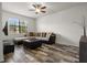 Cozy living room featuring stylish wood-look flooring, plush sectional sofa, and ample natural light at 10111 Tierra Bella Dr, Orlando, FL 32825