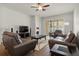 Inviting living room featuring two sofas, two armchairs, a ceiling fan, and sliding doors to the backyard at 10111 Tierra Bella Dr, Orlando, FL 32825