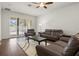 Comfortable living room featuring two sofas, a ceiling fan, and sliding doors to the backyard at 10111 Tierra Bella Dr, Orlando, FL 32825