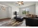 Open-concept living area with stylish flooring, comfortable seating, and a large window for natural light at 10111 Tierra Bella Dr, Orlando, FL 32825