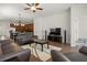 Spacious living room featuring tiled floors, ceiling fan, sofas, and connecting kitchen and dining areas at 10111 Tierra Bella Dr, Orlando, FL 32825