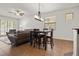 Open-concept living space featuring a dining table, ceiling fan, tiled floors, and a comfortable seating area at 10111 Tierra Bella Dr, Orlando, FL 32825