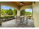 Relaxing covered patio with brick pavers, outdoor seating, and ceiling fan at 10111 Tierra Bella Dr, Orlando, FL 32825