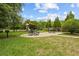 Community picnic area featuring picnic tables, grills, and a playground at 10111 Tierra Bella Dr, Orlando, FL 32825