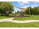 A colorful playground features a slide and climbing structure in a grassy area at 10111 Tierra Bella Dr, Orlando, FL 32825