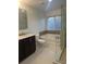 Bright bathroom featuring a soaking tub, separate glass-enclosed shower, and elegant vanity at 10148 Malpas Pt, Orlando, FL 32832